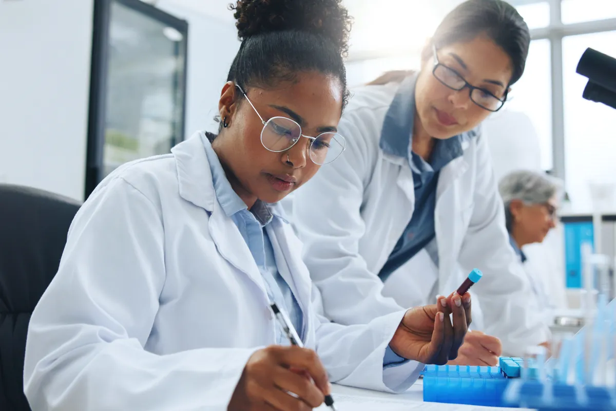 Scientists evaluating a blood sample in a lab.